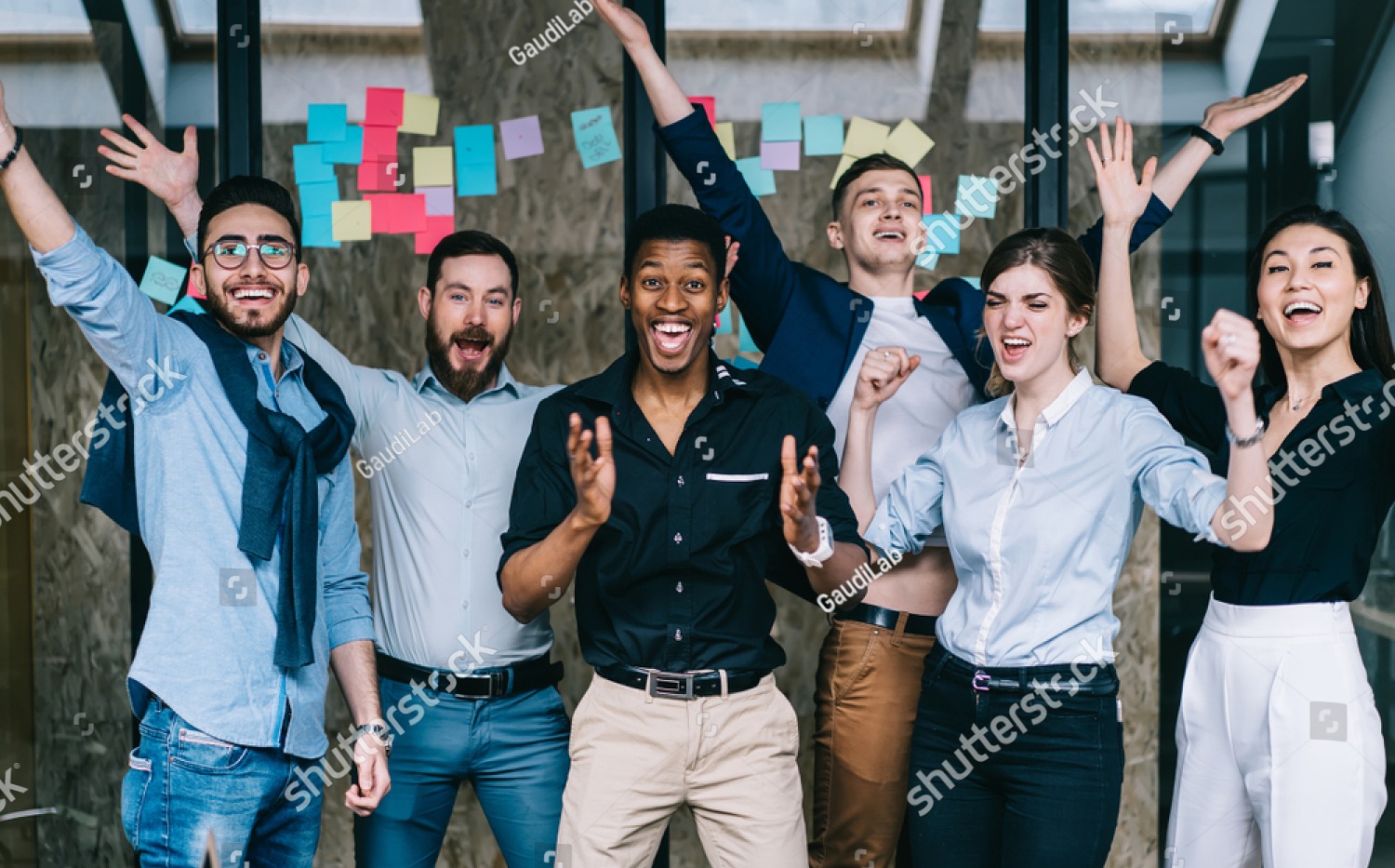 stock-photo-young-crew-of-happy-excited-male-and-female-business-partners-celebrating-completed-startup-project-1388850572